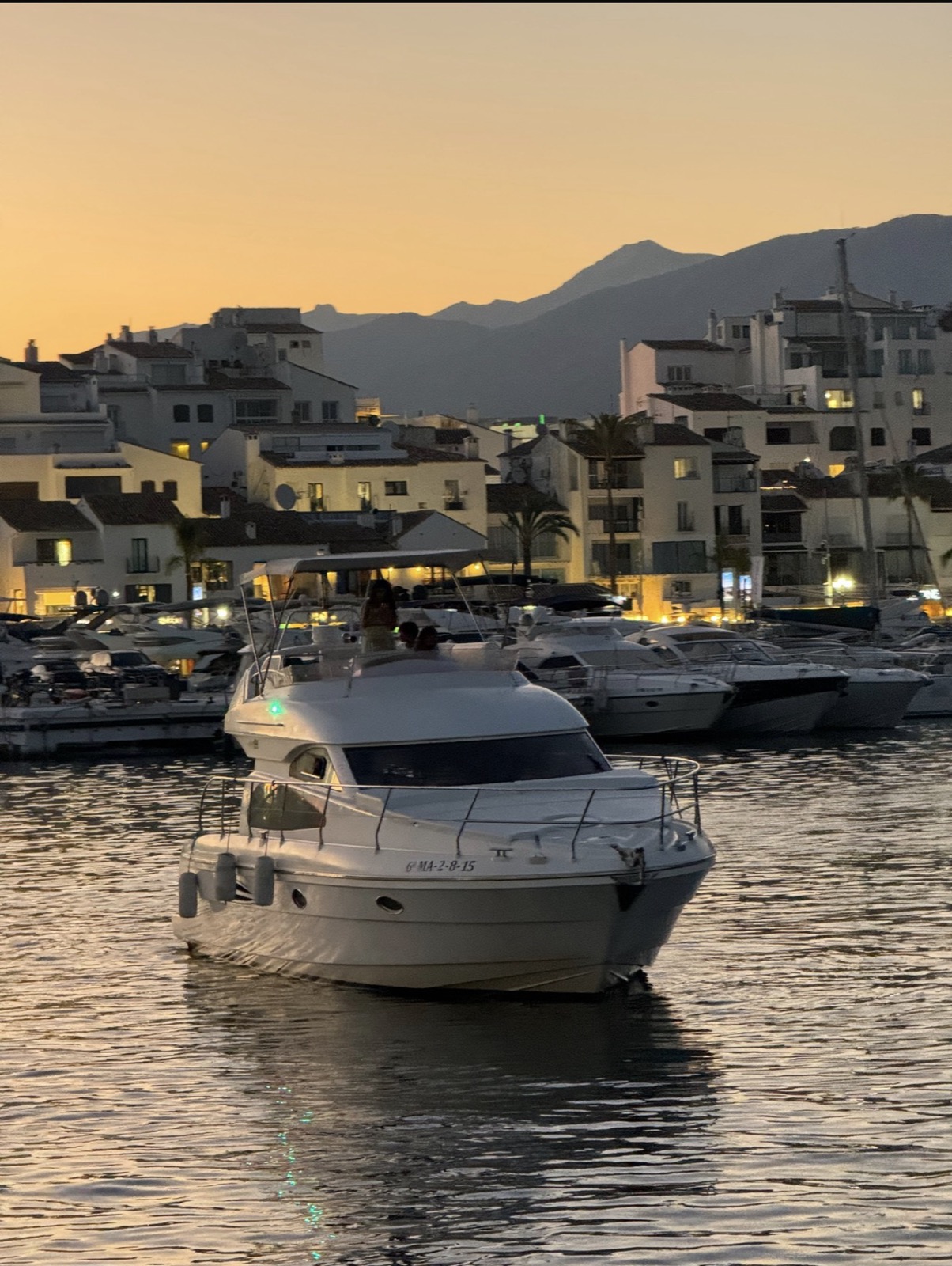 Anniversary yacht charter Marbella — Astondoa 40 at Puerto Banús sunset