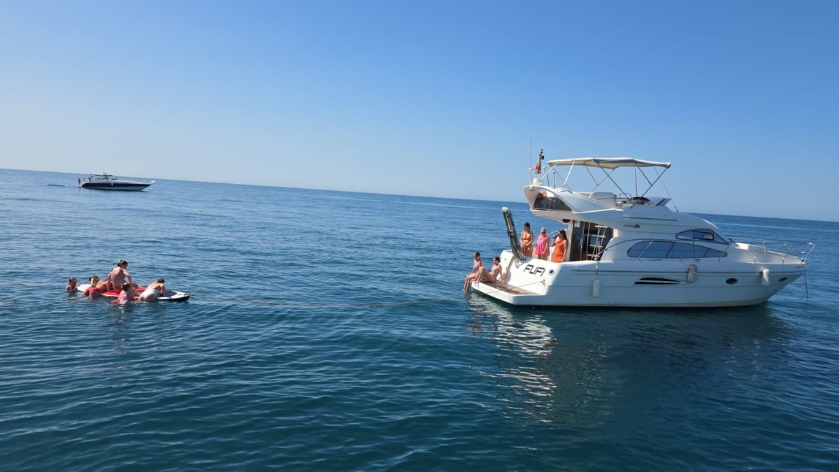 Guests on the towable float behind the Astondoa 40 "Fufi"