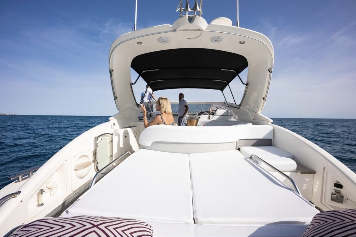 Guests relaxing on the foredeck of the Fairline Targa 12m