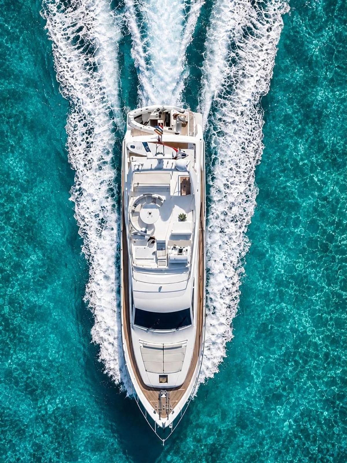 Aerial view of the Ferretti 680 underway, twin wake trailing behind