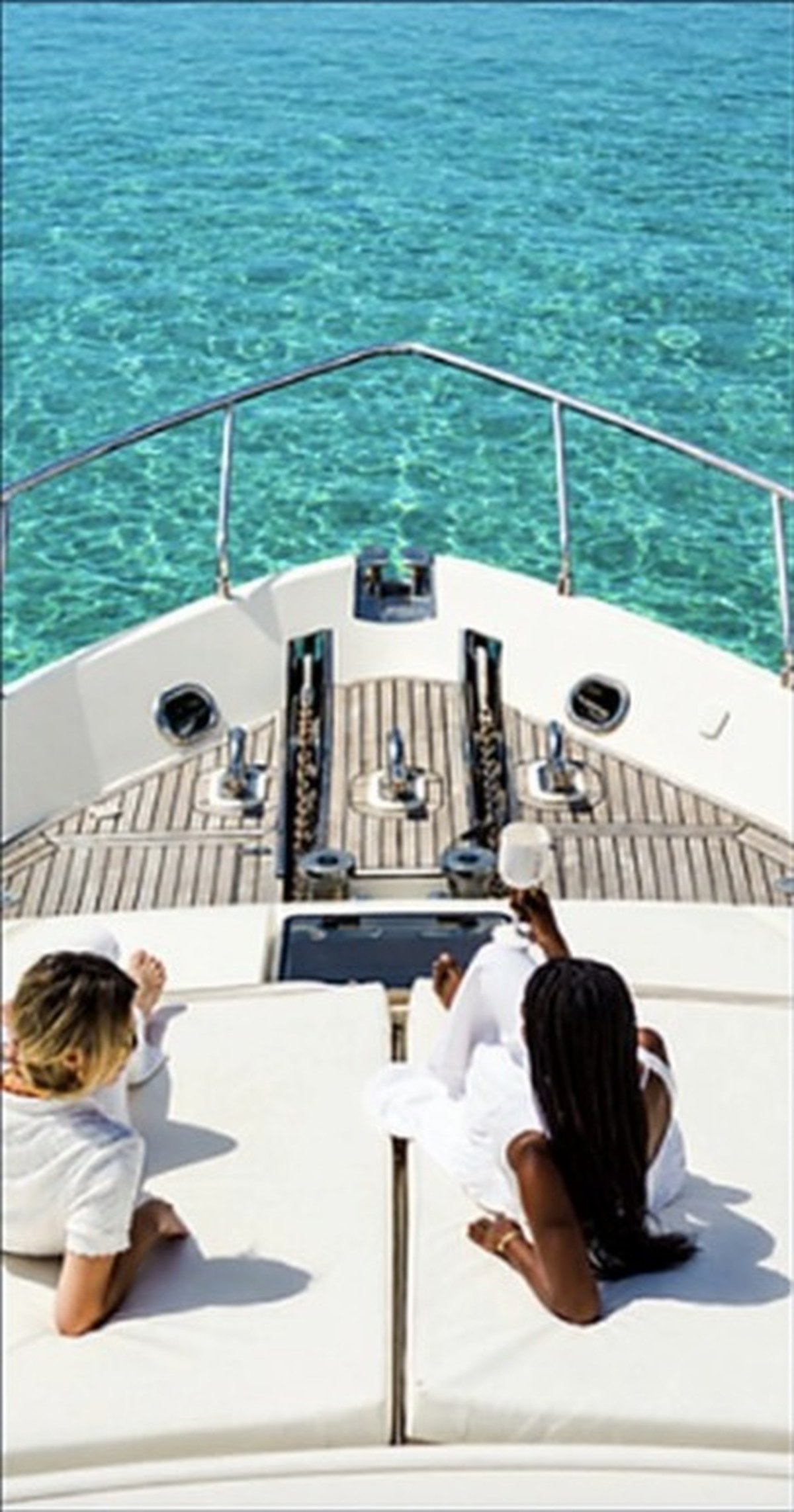 Guests relaxing on the bow of the Ferretti 680 off Marbella