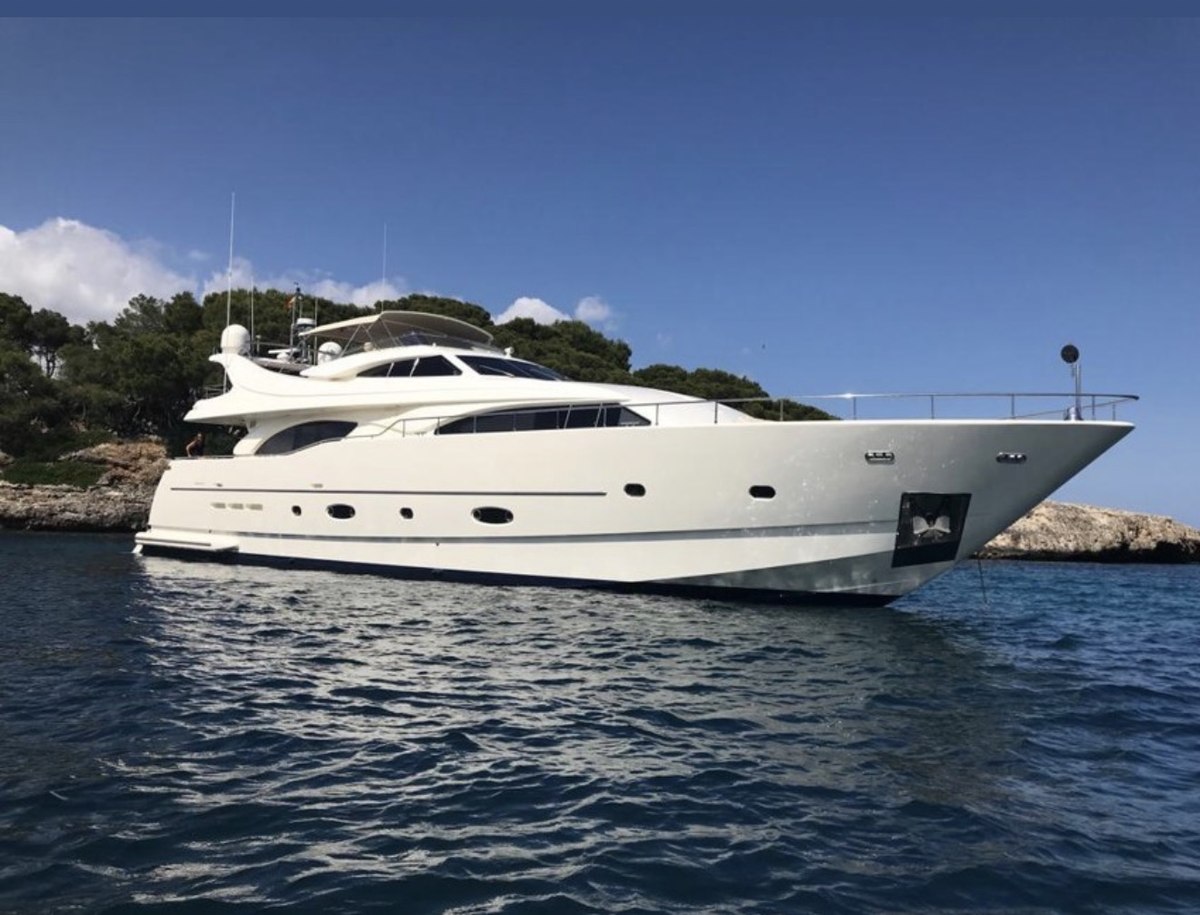 Ferretti 94 anchored off a secluded cove