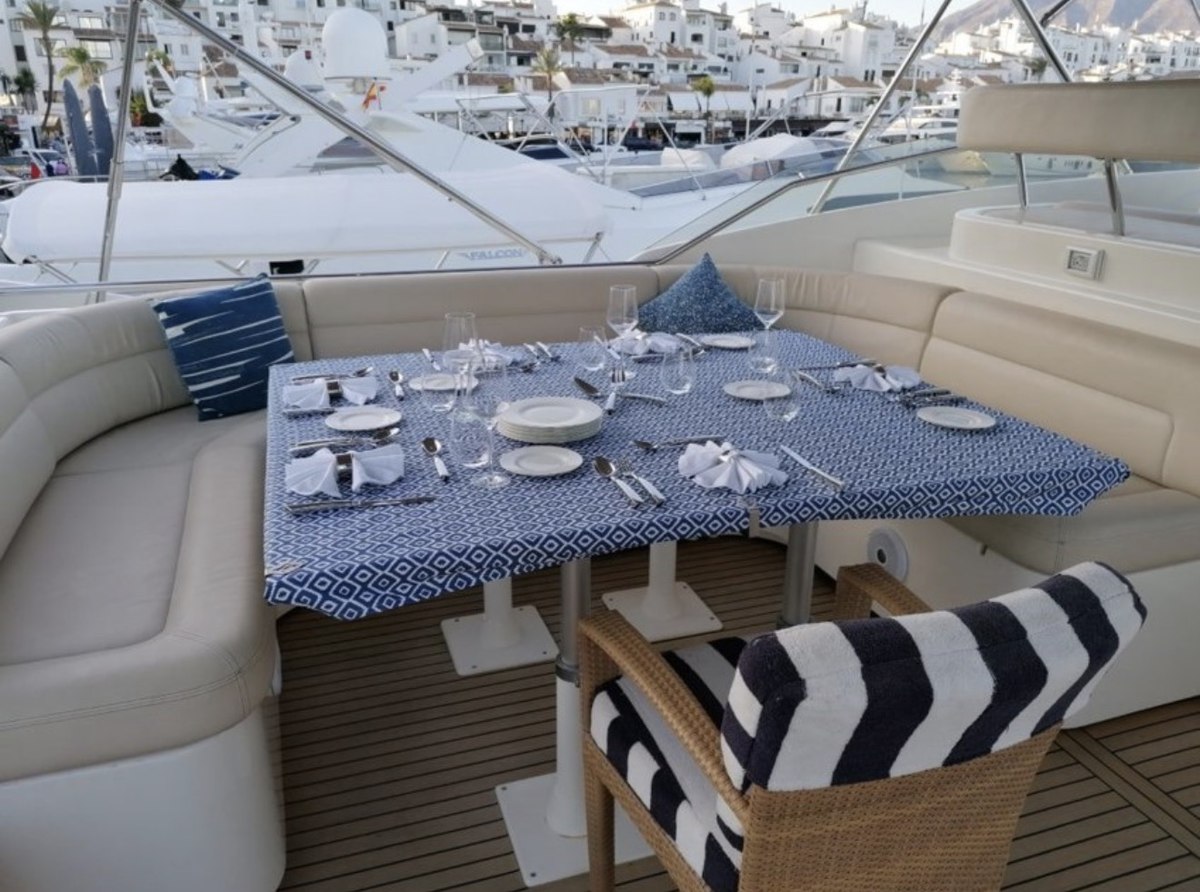 Ferretti 94 formal dining setup on deck at Puerto Banús