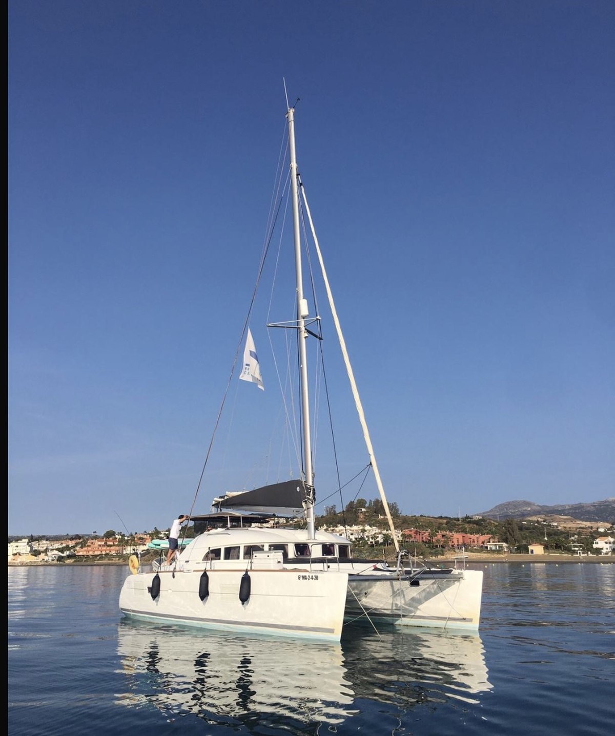Lagoon 380 under sail with mountain backdrop