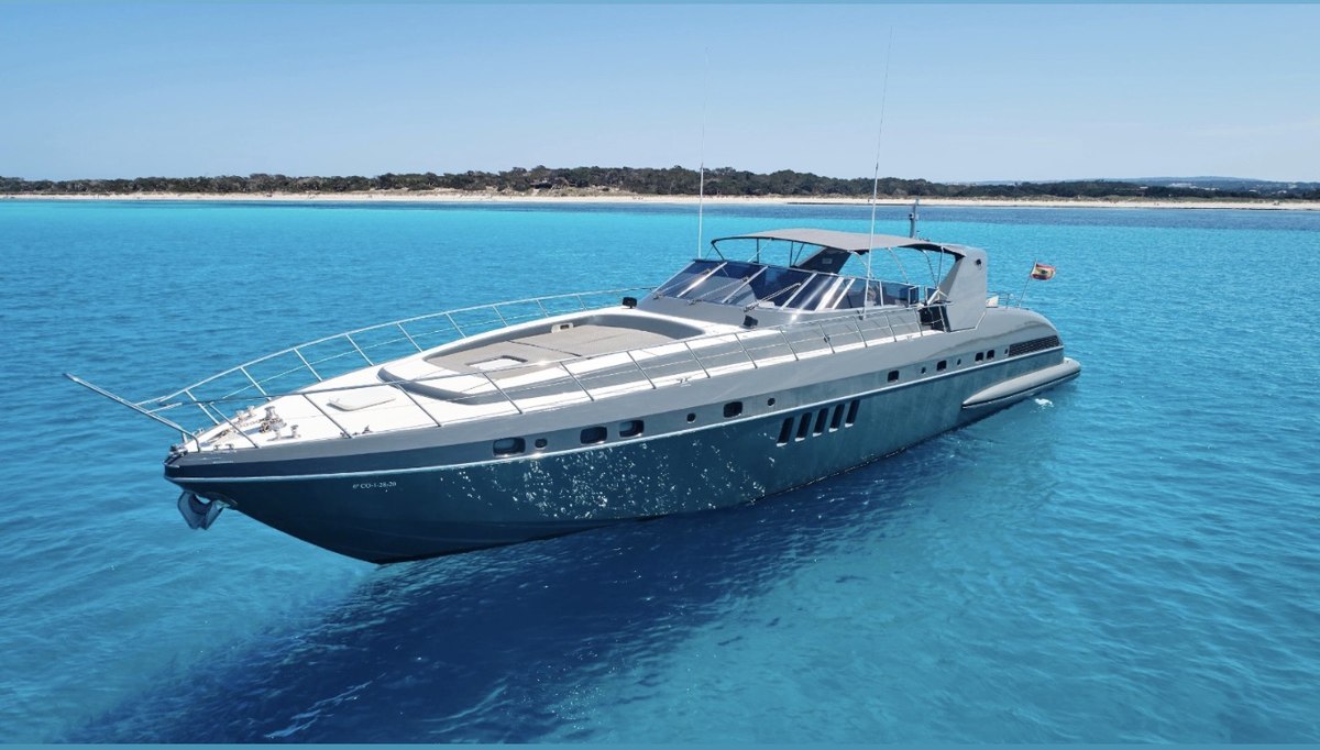 Mangusta 80 Grey anchored off a pristine beach