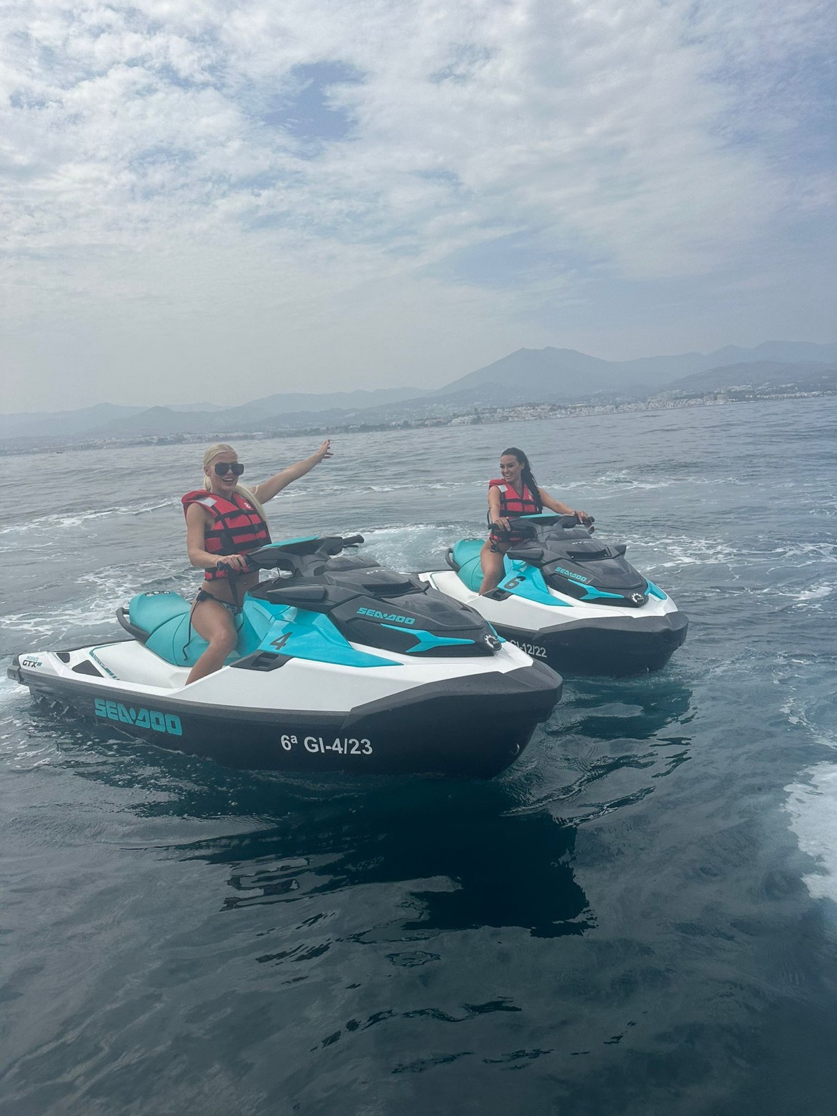 jet ski rental Marbella — Sea-Doo jet ski rental Marbella — two riders cruising past the Marbella mountains