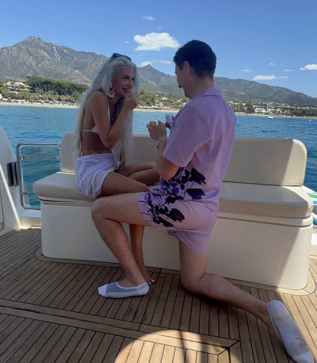 The yes moment on a Marbella yacht proposal — La Concha mountain behind, sunset light