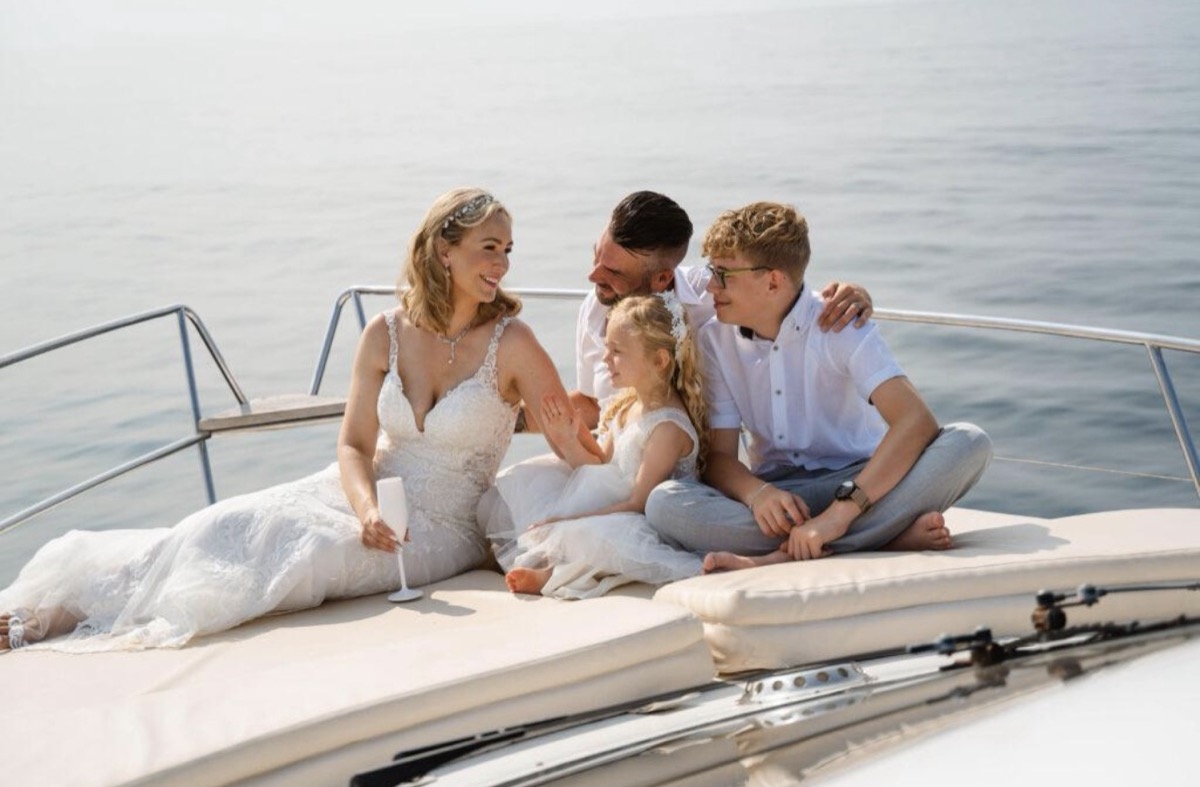 Bride and groom with their family on the bow sun pad after a Marbella yacht wedding